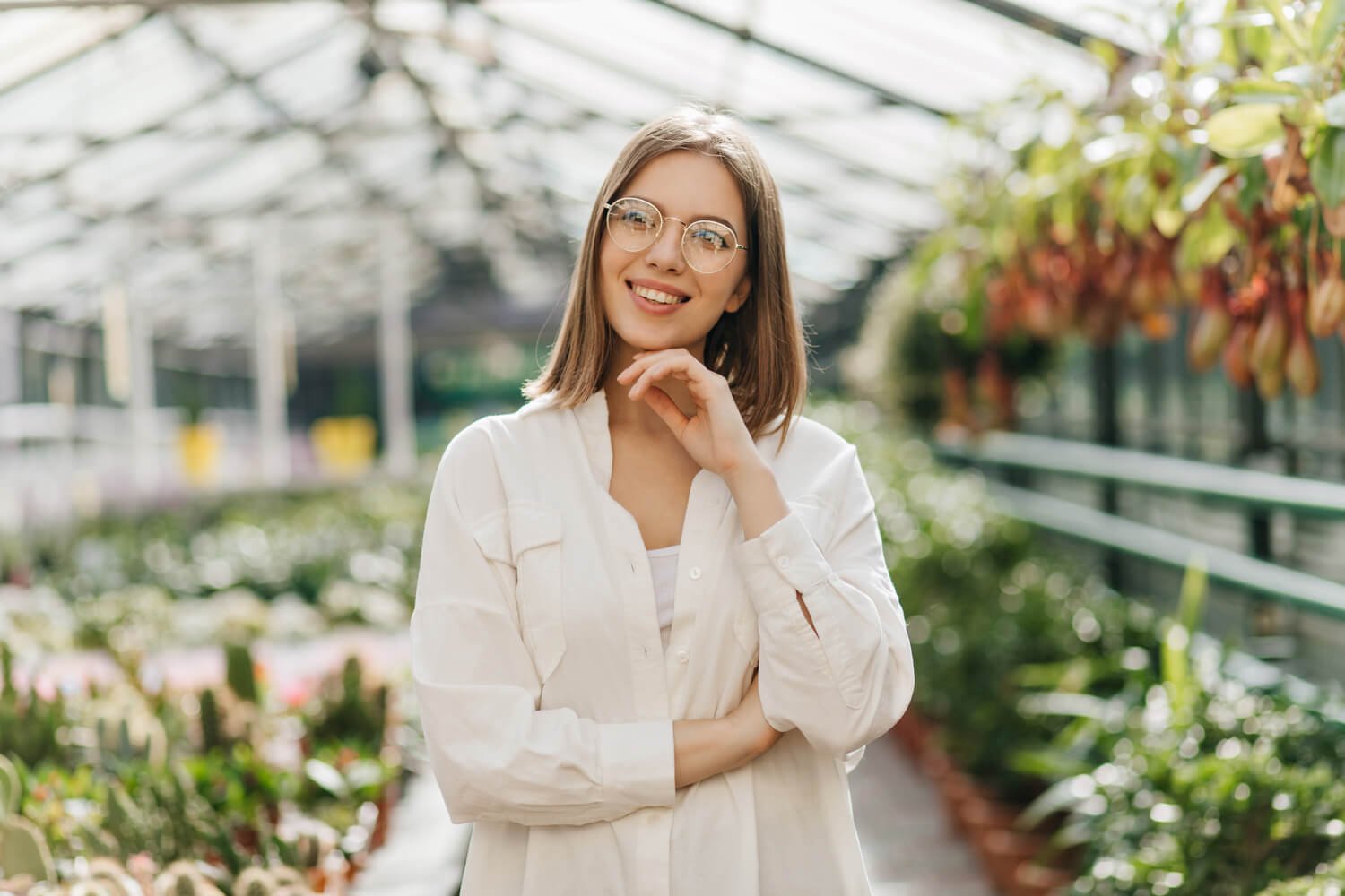 pensive dark haired girl standing in greenhouse p v1 UT8DRCZ OhWellnessCenter Houston EBOO